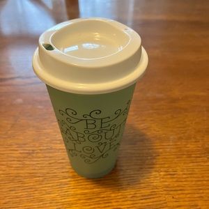 Reusable Starbucks coffee mug.